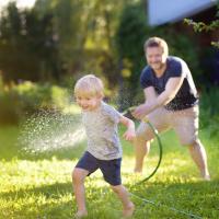 Father and son playing in their yard.