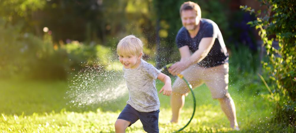 Father and son playing in their yard.