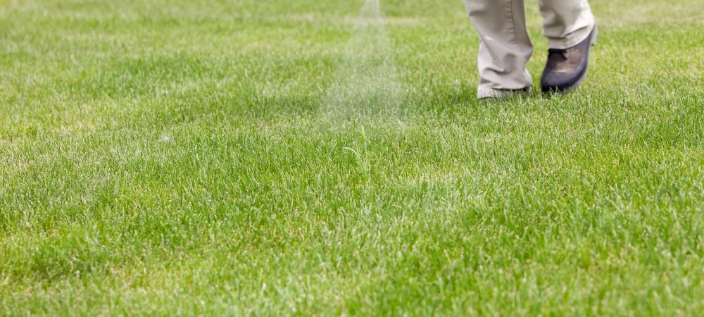 lawn care technician performing liquid aeration